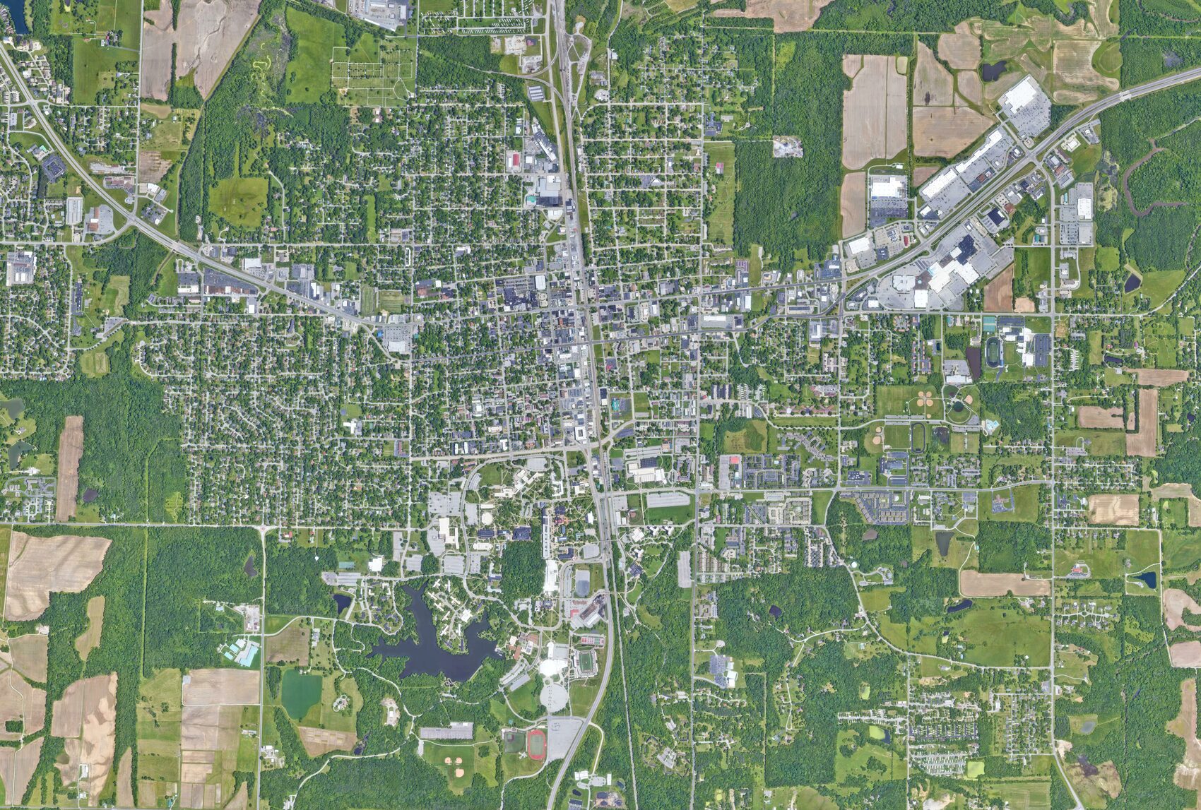 Carbondale from above — the downtown core, the Southern Illinois University campus and its lake, and the retail corridor toward the mall. BusinessFlare®.